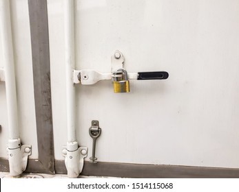 Golden lock Locking the white steel door behind the transport truck - Shutterstock ID 1514115068