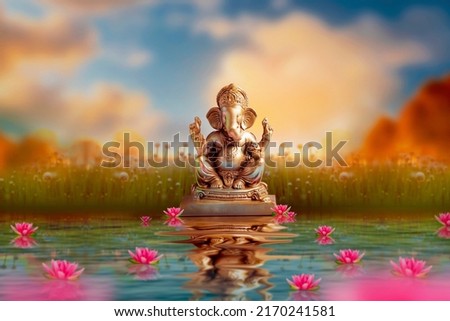 Golden lord ganesha sculpture on nature background. celebrate lord ganesha festival.