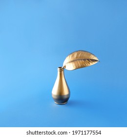 Golden luxury flower vase with golden leaf on a blue background. Minimal concept. Elegant composition. - Shutterstock ID 1971177554