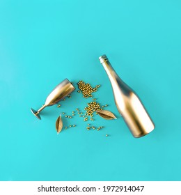 Golden luxury wine glass and bottle on a turquoise background. Blue background. Minimal concept. Elegant composition. - Shutterstock ID 1972914047