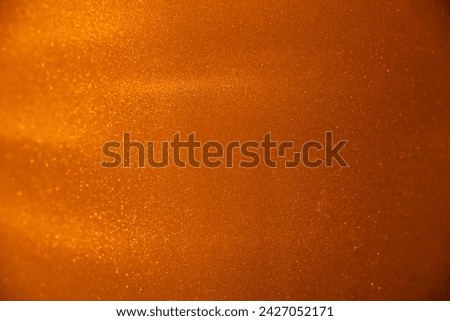 A golden macro shot, shimmering particles suspended in space.
