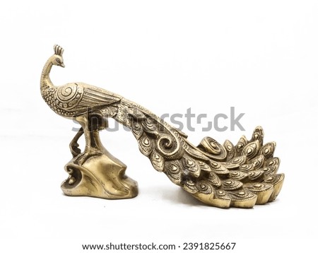 golden male peacock figurine with stand handcrafted and decorated with ornate details isolated in a white background