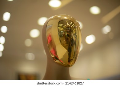 Golden Mask On Mannequin. Reflection In Showcase.Figure Of Person. Face Without Details.