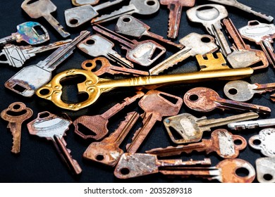 Golden master key in the center of the image. with pattern many keys on black floor