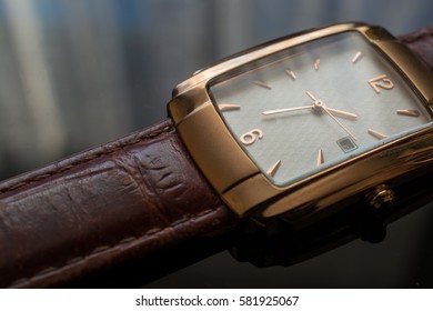 Golden Men's Wristwatch on A Black Background. Classic Wristwatch for Man with Brown Strap.