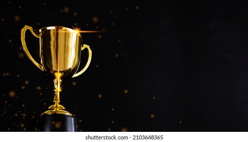 Golden metal glasses on old wooden table background, place for copy space. Golden wooden table with golden trophy on dark background. Ready for new year celebration design. Festive light background. - Shutterstock ID 2103648365