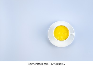 Golden Milk And On A Blue Background With Copy Space. Masala Haldi Doodh. Alternative Medicine Concept.