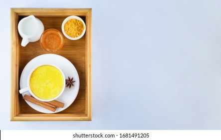 Golden Milk, Turmeric, Honey, Cinnamon And Star Anise On A Wooden Tray On A Grey Background. Masala Haldi Doodh.