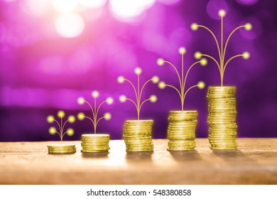 Golden Money Pile Coins On Wood Table With Artificial Tree Growth Concept