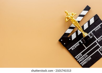 Golden Movie Award Statue With Cinema Clapper Board