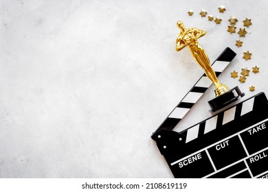 Golden Movie Award Statue With Cinema Clapper Board