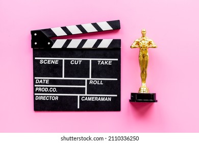 Golden Movie Award Statue With Cinema Clapper Board