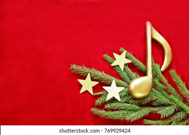 Golden Music Note On Christmas Tree  Branch With Stars On Red Velvet 