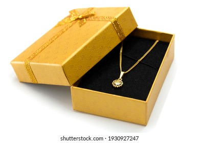 Golden Necklace In A Gift Box, White Background 