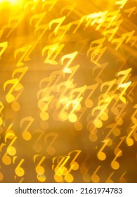 Golden note shape bokeh on brown background, Abstract yellow shining musical note shape bokeh. Vertical