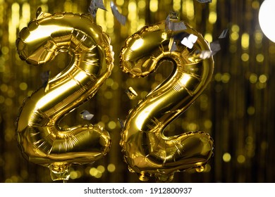 Golden Number 22 Twenty Two Made From An Inflatable Balloon, On A Yellow Background. One Of The Complete Set Of Numbers. The Concept Of Birthday, Anniversary, Date