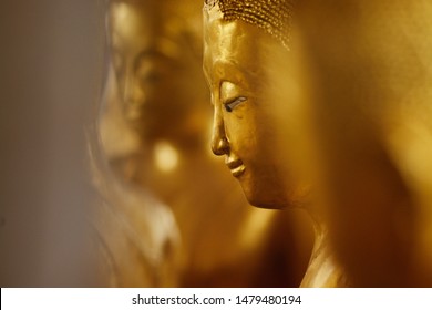 Golden Ordained Buddhist nun or Bhikkunis surround Buddha's sculpture.These are some of the oldest and rarest Bhikkuni statues found in the world at Wat Thepthidaram temple. - Powered by Shutterstock