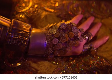 Golden Oriental Jewelry Accessories: Female Hands with beautiful National Indian Jewellery, Eastern Fairy Tale (Harem), Wedding Fashion. Eastern Treasure Chest by Candlelight. Luxury Arabian Interior 