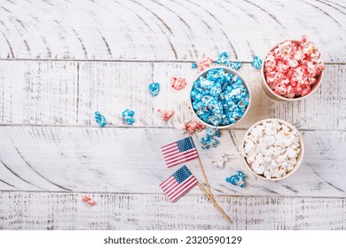 Golden paper cups with red, blue, white popcorn. US colors for 4th july. Snack food for USA independence day celebration - Powered by Shutterstock