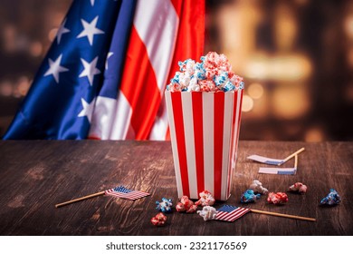 Golden paper cups with red, blue, white popcorn. US colors for 4th july. Snack food for USA independence day celebration - Powered by Shutterstock