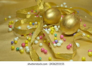 Golden Paschal eggs, Easter eggs with ribbon and colorful balls. - Powered by Shutterstock