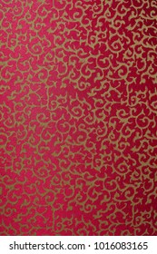 golden patterns on a red background