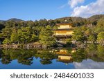 The Golden Pavilion of the Kinkakuji Temple by the pond surrounded with Japanese garden in Autumn season at Kyoto,Japan