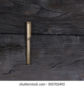 Golden Pen On A Black Table