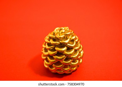 Golden Pinecone Reflecting The Image Of Magnificence And A Gold Medal