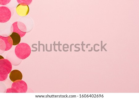 Golden and pink confetti on pink color paper background minimal style macro view with copyspace