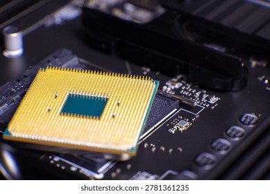Golden pins of a central processing unit (CPU) are shown resting above a motherboard socket, highlighting intricate electronic components and modern computer hardware. Focus on tiny pins and chip cont