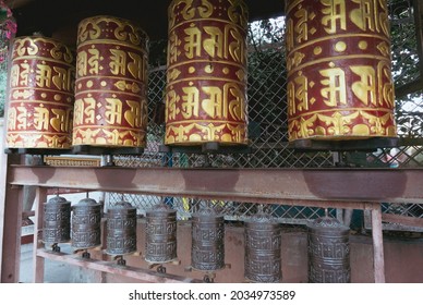 Golden prayer wheels with tibetan mantra "Om Mani Padme Hum" written on it, which means: The Jewel is in the Lotus. Prayer wheels from Swayambhunath Temple in Kathmandu, Nepal.