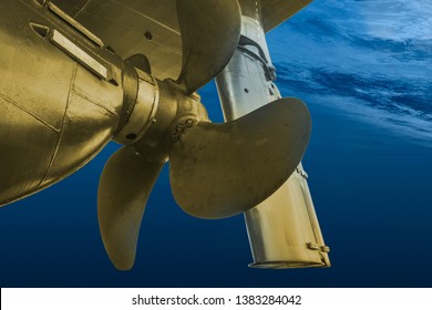 Golden propeller and rudder of big ship underway view. Close up image detail of ship. Transportation industry. Freight transportation. Ship repair, underwater survey and shipping business concept.