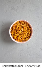 Golden Raisins In A Pink Bowl On A Gray Surface, Top View. Flat Lay, Overhead, From Above. 