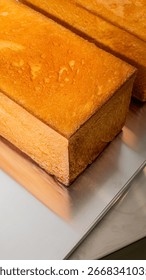 Golden rectangular sponge cake whispers rustic nostalgia, invoking thoughts of Nian Gao festivities and cozy hearthside tea ceremonies