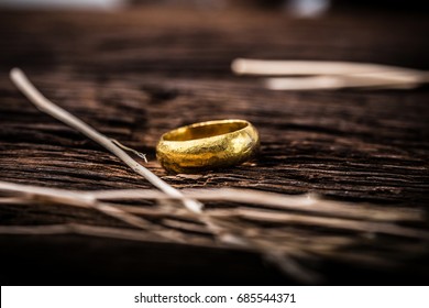 Golden ring on wooden background. - Shutterstock ID 685544371