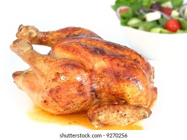 Golden Roasted Chicken, With Bowl Of Greek Salad.  Focus On Chicken.