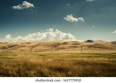 Golden Rolling Hills And Power Lines In Central California.