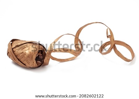 Golden rough paper string in a roll isolated on a white background