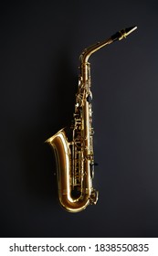Golden saxophone on dark grey background - Shutterstock ID 1838550835