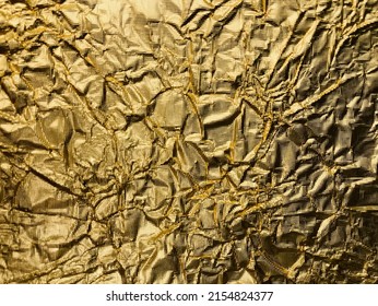 The golden shimmering surface metal foil and folds
