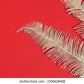 Golden shiny branches on the red background. Abstract luxury wallpaper. Flay lay decoration concept.