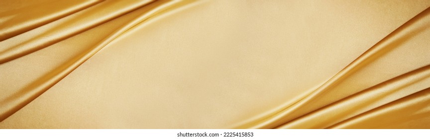 Golden silk satin. Luxury royal rich background with space for design. Soft folds. Shiny smooth fabric. Banner. Wide. Long.Panoramic.Anniversary, award, reward, Christmas, Birthday, wedding. Template. - Shutterstock ID 2225415853