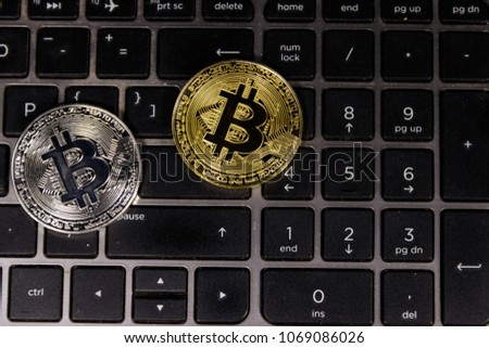 Golden and silver bitcoin on laptop keyboard. Cryptocurrency virtual money
