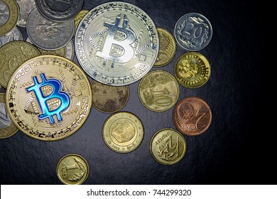 golden and silver bitcoins and simple coins on black background