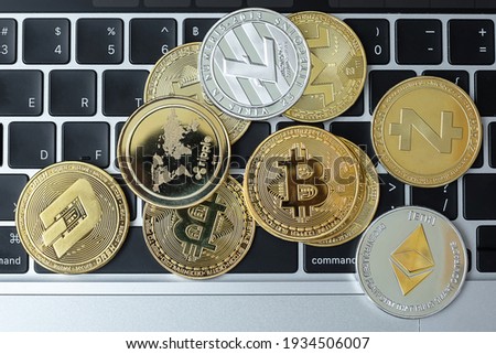 golden and silver Cryptocurrency on keyboard laptop, Bitcoin , Ethereum, Litecoin, Dash, Monero, Zcach and Ripple coins. Crypto is Digital Money within the blockchain network