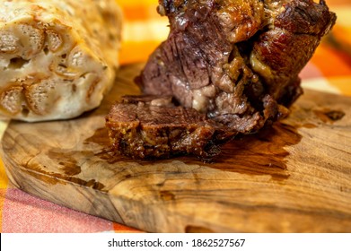 Golden slowly baked piece of juicy peeled shoulder beef (clod, or fake sirloin) with jelly tendon full of collagen on kitchen board, part of dumpling. - Shutterstock ID 1862527567