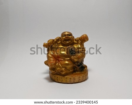 The Golden smiling Buddha or Hotei is the chinese god of happiness, wealth and good luck. Close-up