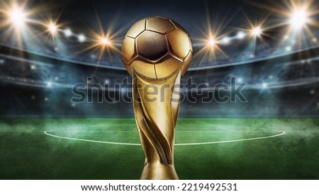 Golden soccer winner s cup in the middle of a soccer stadium
