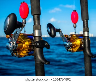 Golden Sport Fishing Rod And Reels Set Up For Sailfishing Off The Coast Of West Palm Beach, Florida. The Blue Line And Golden Reels Mess Beautifully With The Blue Atlantic Ocean.